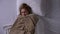 Woman covering with blanket lying in bed, feeling fever, symptoms of cold