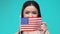 Woman covering mouth by American flag, national symbol, tourism and migration