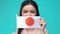 Woman covering mouth by Japanese flag, foreign language school, tourism