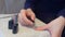 Woman covering nails applying top coat on gel polish at home, hands closeup.