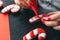 A woman covers with icing Christmas gingerbread in the form of a candy.