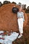 Woman in cowboy hat staying near a straw bale. Summer, beauty, fashion, glamour, lifestyle concept. Cottagecore farmcore