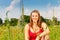 Woman cowering in meadow of field