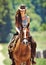 Woman, cowgirl and horse riding in the countryside for journey, travel or outdoor adventure in nature. Female person or