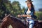 Woman, cowgirl and riding horse in countryside for journey or outdoor adventure in nature. Female person or western