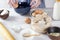 Woman cracking an egg into the blue bowl, baking cake process.Base ingredients for baking on the kitchen table