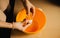 Woman cracking an egg into a bowl. The image highlights joy of homemade cooking, where every ingredient is carefully selected and