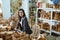 woman craft designer looks at the camera while standing in a craft workshop