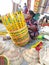 A woman craft worker making a colourful bamboo basket at Calcutta handicraft trade fair ground 2021.