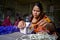 A woman crafts maker is making a showpiece home from the fibers of a banana tree at Madhupur, Tangail