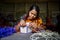 A woman crafts maker is making a showpiece home from the fibers of a banana tree at Madhupur, Tangail