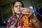 A woman crafts maker is making a showpiece home from the fibers of a banana tree at Madhupur, Tangail, Bangladesh