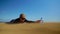 A woman crawling for a bottle of water on the sand desert in slow motion