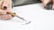 Woman create a calligraphy design work using drawing pen and ink