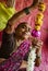 Woman creates flower leis for decoration