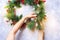 Woman Creates Green Christmas Decorative Wreath