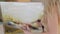 Woman creating painting with oil paints and brush, slow motion