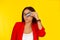 Woman with credit card covering eye posing with puckered lips