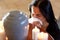 Woman with cremation urn at funeral in church