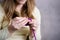A woman crochets a product from soft, fluffy, purple yarn. Crochet process