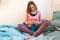 Woman crochets sitting in bed during quarantin