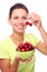 Woman with crockery of cherries in her hands.