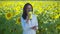 Woman crop scientist working in sunflower field