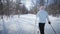Woman Cross-Country Skiing Alone in Nature
