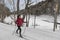 Woman Cross Country skiing Classic Style Nordic Skiing in Forest. Woman in winter doing fun winter sport activity in the