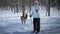 Woman Cross-Country Skiing With Deer