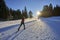 Woman cross-country skiing short before sunset in the Bregenz Forest Mountains