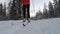 Woman cross-country skiing in the snowy forest