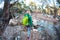 A woman crosses a stream.