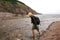 Woman Crossing River at Ocean