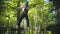 Woman crossing a rope - an entertainment attraction in the forest for young people