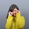 Woman crying and wiping tears against gray background