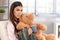 Woman cuddling with teddy bear
