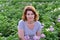 Woman cultivates potatoes on a summer residence