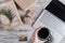 Woman with cup of coffee, credit card and tablet. Packing gifts. Cardboard box in craft paper on the rustic wood planks background