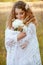 Woman with curly golden hair smiling standing in the field