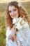 Woman with curly golden hair smiling standing in the field