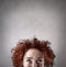 Woman with curly hair thinking