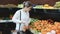 woman customer choosing fresh fruits on the market