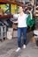 Woman customer holding purchases and walking in modern build store