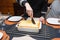 Woman cut with knife hot tasty home baking lasagna in ceramic casserole dish