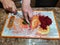 Woman cut parsley on chopping board with beetroot