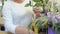 Woman cut roses and make flower composition