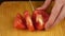 Woman cut tomato on cutting board for salad or juicing. healthy food and dieting concept. slow motion