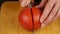 Woman cut tomato on cutting board for salad or juicing. healthy food and dieting concept. slow motion