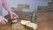 Woman is cuting the pineapple on a cutting board. Hands closeup. High speed video.